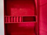 a red box that has a bunch of lipstick in it