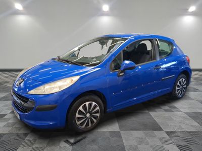 a blue car parked in a garage with a checkered floor