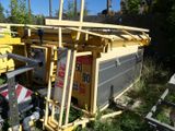 a yellow crane that is sitting next to a building