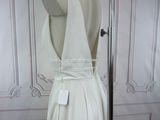 a white dress on a mannequin stand in a room