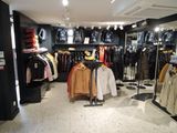 a picture of a clothing store with a lot of clothes