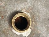 a close up of a metal pipe with a hole in it