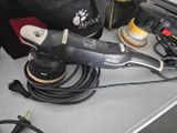 a picture of a corded sander and other tools on a table