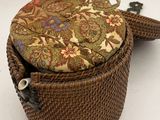 a close up of a wicker bag with a flower pattern on it
