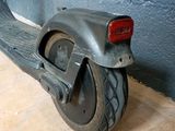 a scooter that is sitting on the floor next to a wall