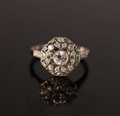 an antique diamond ring on a black surface