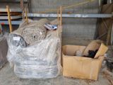 many rolls of fabric in a box on the floor
