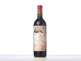 bottle of red wine sitting on a table with a white background