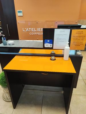 the front desk of a coffee shop with a sign on it
