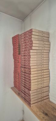 a stack of pizza sitting on a shelf in a room