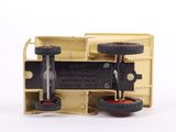 a yellow toy truck with wheels on a white surface