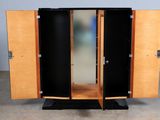 a wooden cabinet with two doors open on the floor