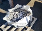 a bag full of small pieces of metal sitting on a pallet