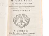 an open book on a white surface with a black and white title