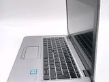 a silver laptop computer sitting on top of a white table