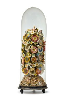 a glass bellow with a bunch of flowers inside of it