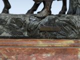 a statue of a man riding a horse on a rock