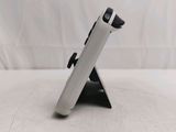 a white tablet computer sitting on a stand on a table