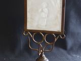 a picture of a woman in a picture frame on a stand