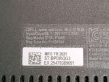 the back side of a dell laptop with a sticker on it
