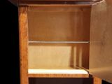 a small cabinet with a door open on a black background
