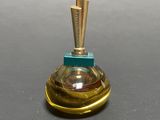 a small glass bottle with a wooden handle on a table