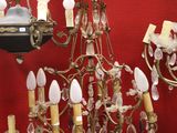 a chandelier that is hanging from a red wall
