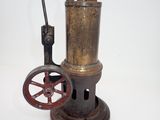 a small old fashioned steam engine on a white surface