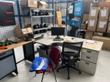 a desk with a chair and a computer on it in a room