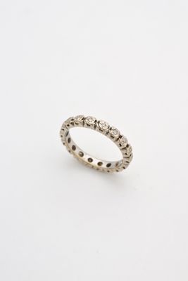 a white gold ring with black diamonds on a white background