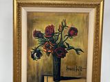 un tableau représentant des roses dans un vase posé sur un chevalet