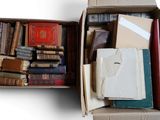 a box full of books sitting on a white surface