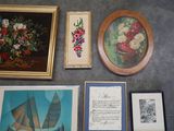 many framed pictures on the wall of a room