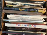 a lot of books in a cardboard box on the table