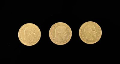 three different types of gold coins on a black background