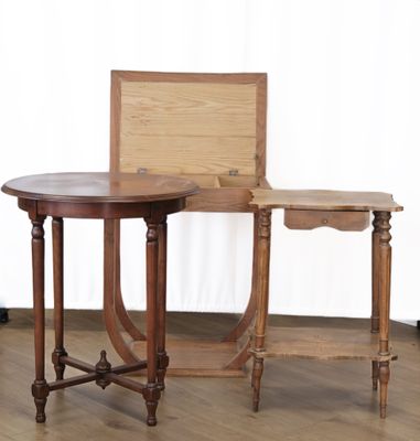 two tables and a chair in a room with a white curtain