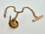 a close up of a gold locke with a chain around it
