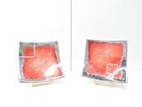 two pieces of fish in a glass dish on a table