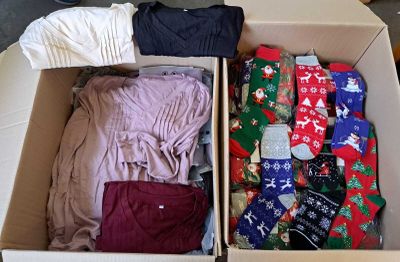 a box full of clothes and socks sitting on the floor