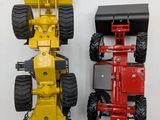 two toy trucks that are sitting side by side