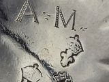 a close up of a silver plate with a clock on it