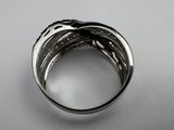 a close up of a silver ring on a white surface