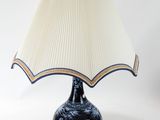 a lamp that is sitting on a table with a lamp shade on it