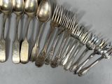 a lot of silver spoons and spoon spoons on the table