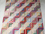 a large patchwork quilt on the floor on the floor