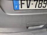 a silver car with a blue license plate on the back of it