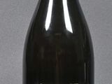 a black bottle with a yellow top on a table