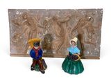 pair of ceramic figurines of a man and a woman
