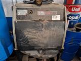 a machine that is sitting next to some blue barrels