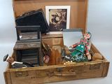 a suitcase with a doll inside of it on a table
